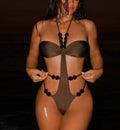 Monokini in tessuto monocromatico con decorazioni in perle e aperture sexy